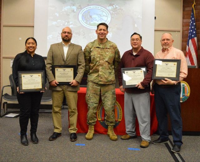 Nina Legaspi (far left) receives the Commanders Certificate for Distinguished Staff at a ceremony at Joint Base Lewis-McChord. 