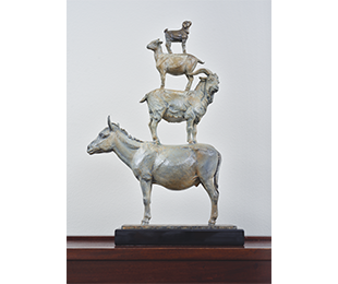 A dog standing on a sheep, standing on a ram, standing on a mule, each facing in alternate directions.