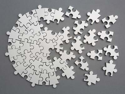 Silver puzzle pieces forming a circular shape.