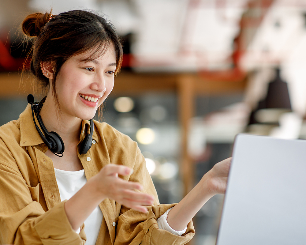 A person smiling and using a computer.