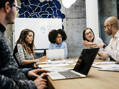 Five people sitting at a conference table.