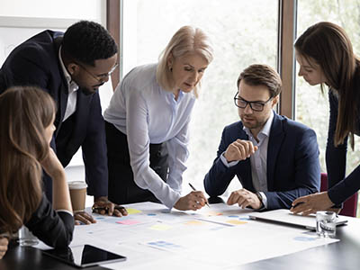 A group of people in business attire working at a table.