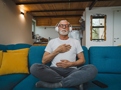 A person wearing headphones and meditating.