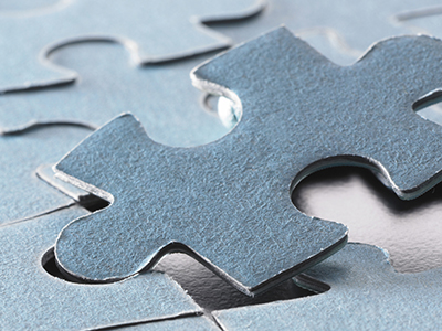 A puzzle piece fitting into a puzzle.