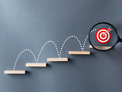 An illustration depicting steps with a target on the top step.