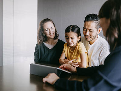 A group of people looking at a digital tablet.