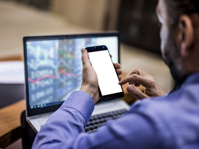 Man with a laptop and smart phone