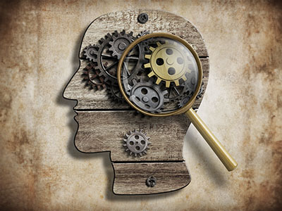 An abstract image of a human head with gears inside of it and a magnifying glass.