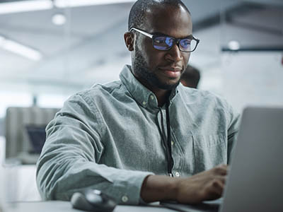 A person typing on a laptop.