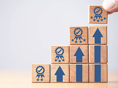 Gradually ascending wooden blocks with the top block having five stars.