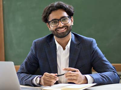 A person in a classroom smiling.