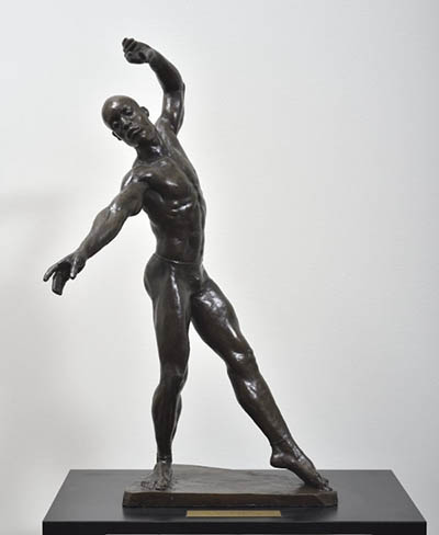 A sculpture of a person in a dramatic pose.