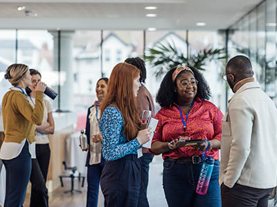 People standing and talking at a reception.