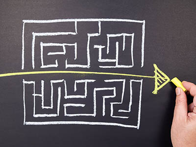 A maze with an arrow drawn directly through the center.