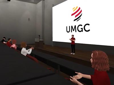 A person giving a presentation with the UMGC logo behind them.