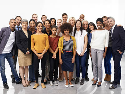 A group of people standing and smiling for a photo.