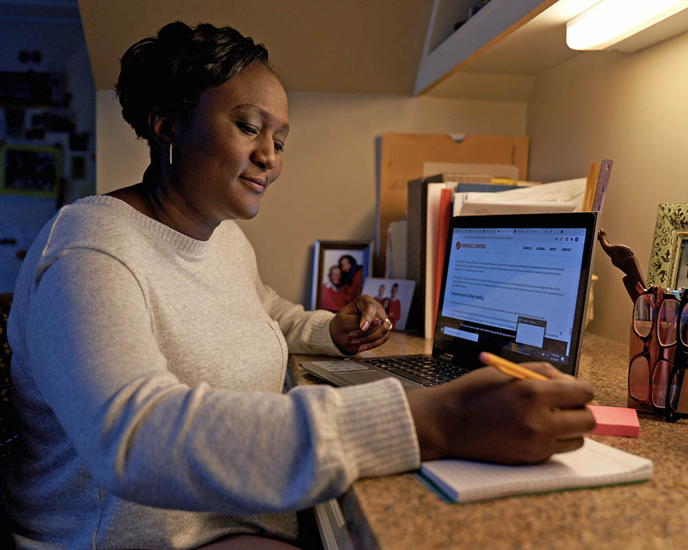 A person writing notes at a desk.