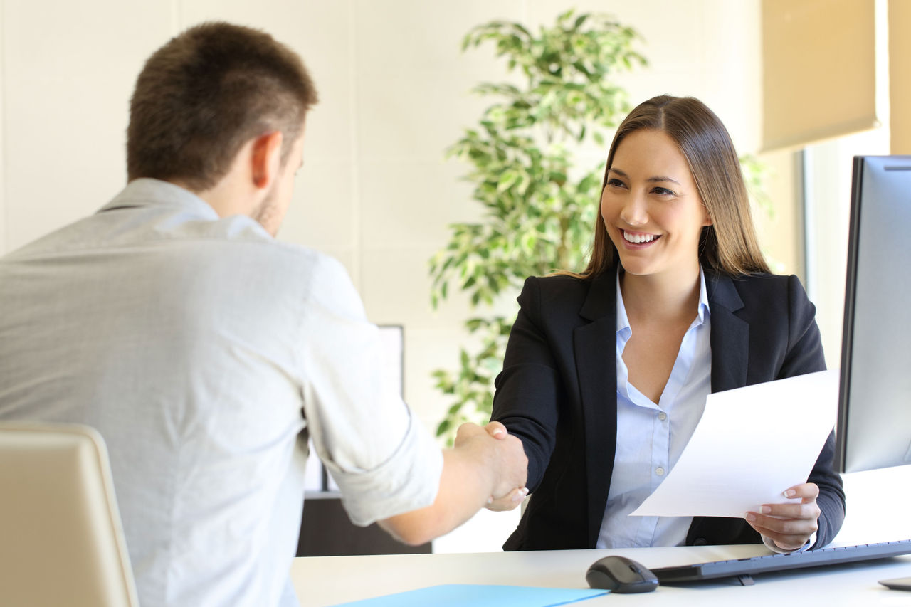 A man being interviewed by a woman.