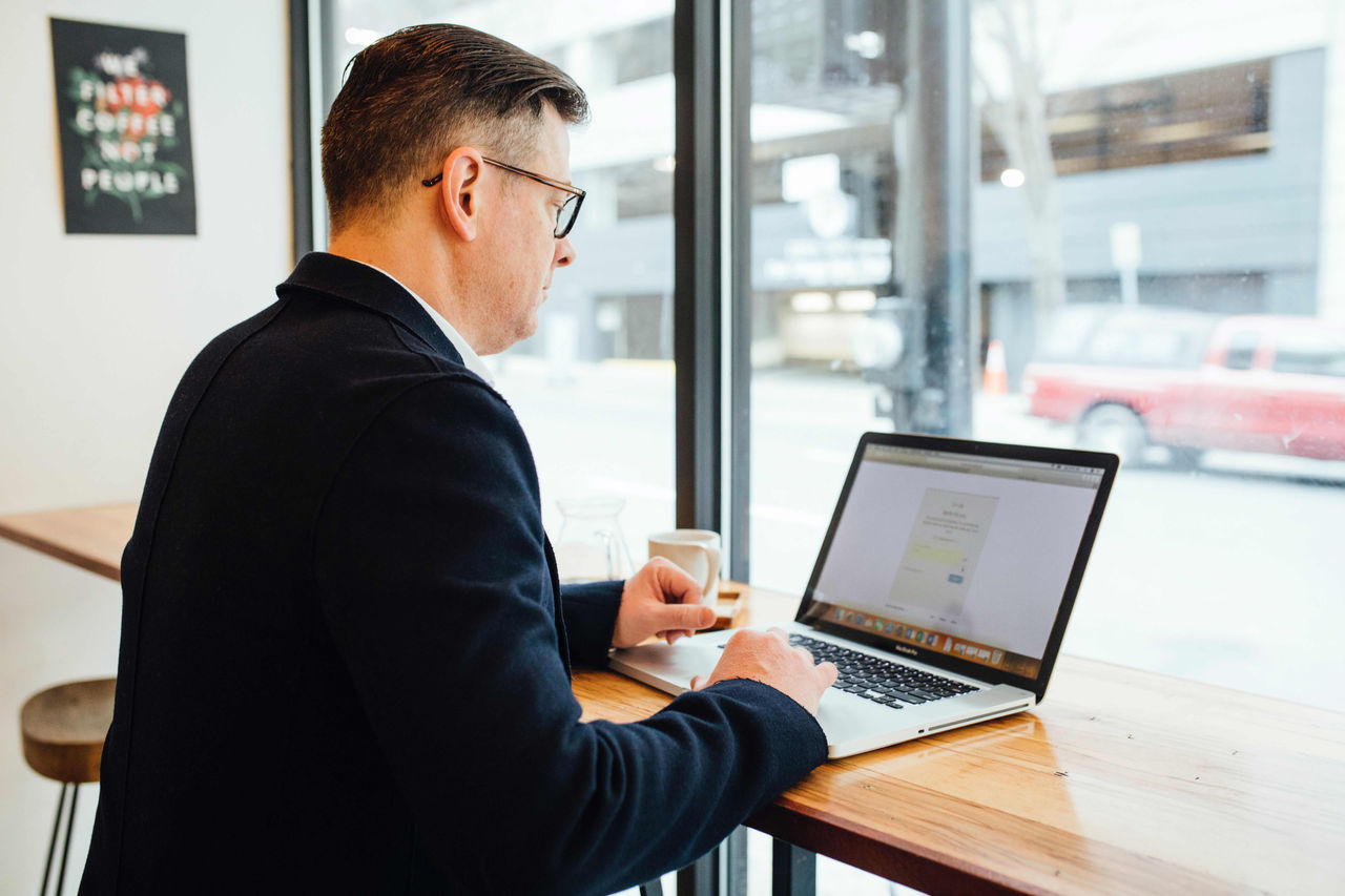 Professional on laptop in coffee shop