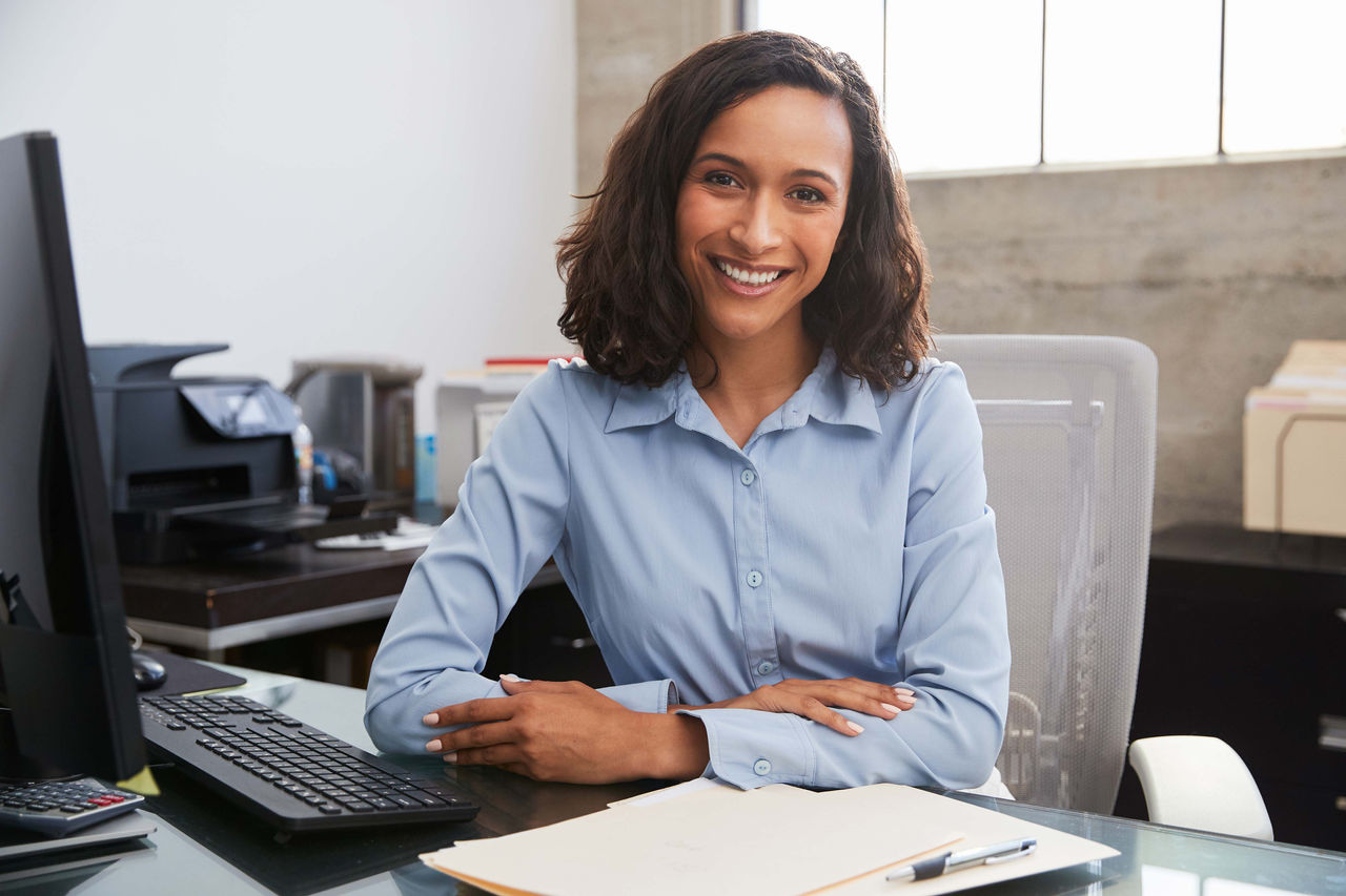 A woman at her desk in her office.