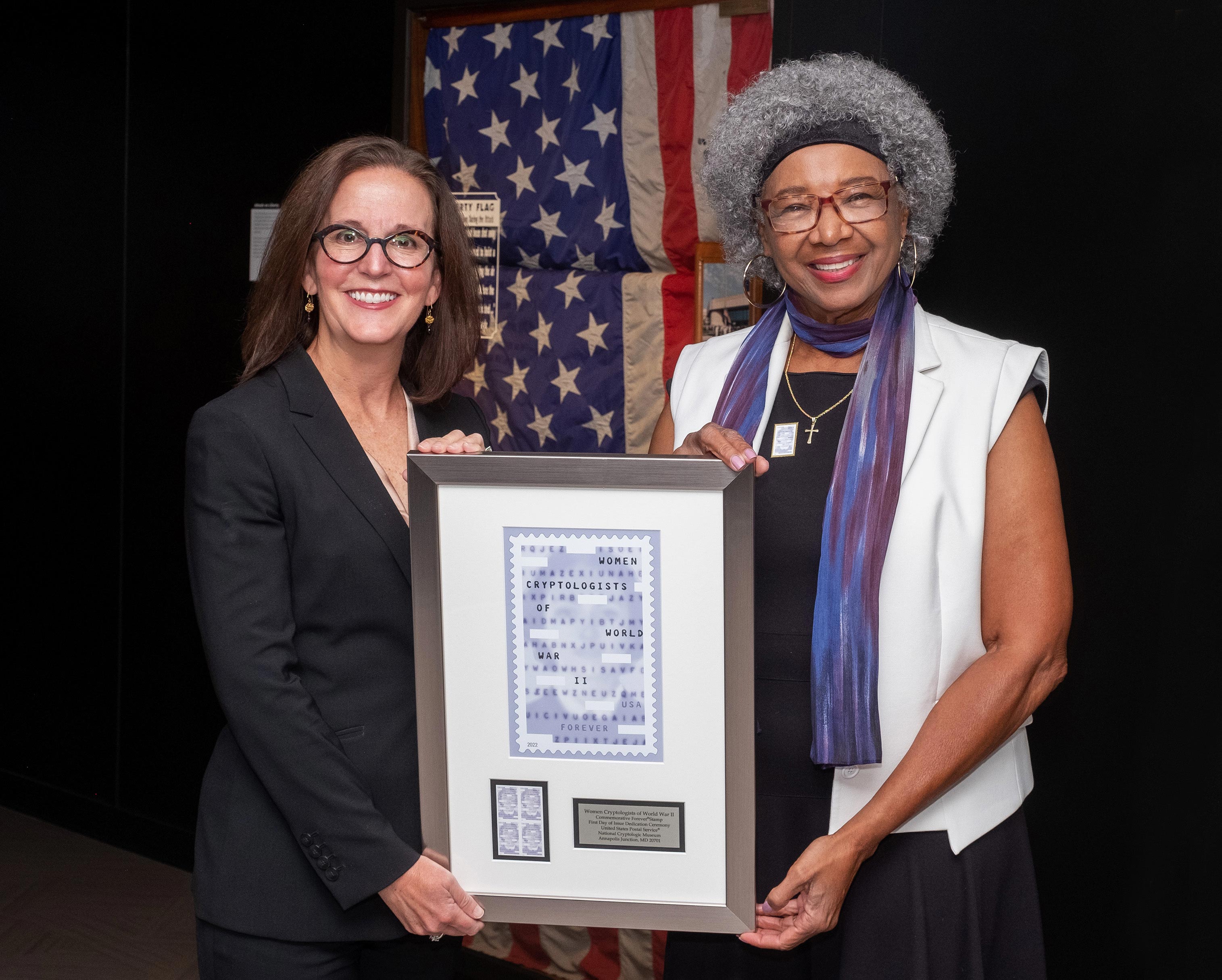 ANNAPOLIS JUNCTION, MD — The U.S. Postal Service honored the work of the Women Cryptologists of World War II with a first-day-of-issue ceremony for the Forever stamp at the National Cryptologic Museum. 
“During World War II, some 11,000 women labored day and night, helping to process and decipher an endless stream of enemy military messages,” said Jakki Krage Strako, the Postal Service’s chief commerce and business solutions officer, who served as the dedicating official for the stamp event. 
“Their work was both frustrating and exhilarating (sometimes simultaneously) —and one of the conflict’s best-kept secrets,” she said. “With this stamp, the U.S. Postal Service honors all of the women cryptologists of World War II, whose service played an inestimable role in the Allied victory.”
The surprise attack on Pearl Harbor made it clear that an enormous and immediate increase in the number of cryptologists was essential. With young men enlisting to serve overseas and more needed every day, the armed forces looked to women. Many women cryptologists were civilians recruited while still in college or working as schoolteachers. By the end of the war, women cryptologists numbered around 7,000 in the Army and about 4,000 in the Navy — more than half of all U.S. cryptologists.
Their service played a significant role in the Allied victory. Women cryptologists deciphered Japanese fleet communications, helped prevent German U-boats from sinking vital cargo ships, and worked to break the encryption systems that revealed Japanese shipping routes and diplomatic messages. They built high-speed machines to break encrypted German messages, intercepted enemy communications, and ensured that encrypted U.S. messages were secure and error-free — an early form of cybersecurity.
Sworn to secrecy — under penalty of treason — the women cryptologists of World War II remained silent about their crucial and far-reaching contributions for decades. Today, they are widely 