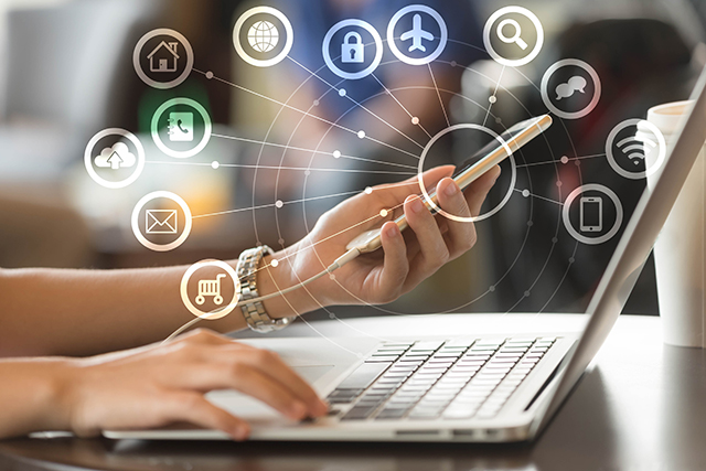 Woman use laptop and smartphone with IOT, internet of things conceptual sign, internet era, internet in every day lifes