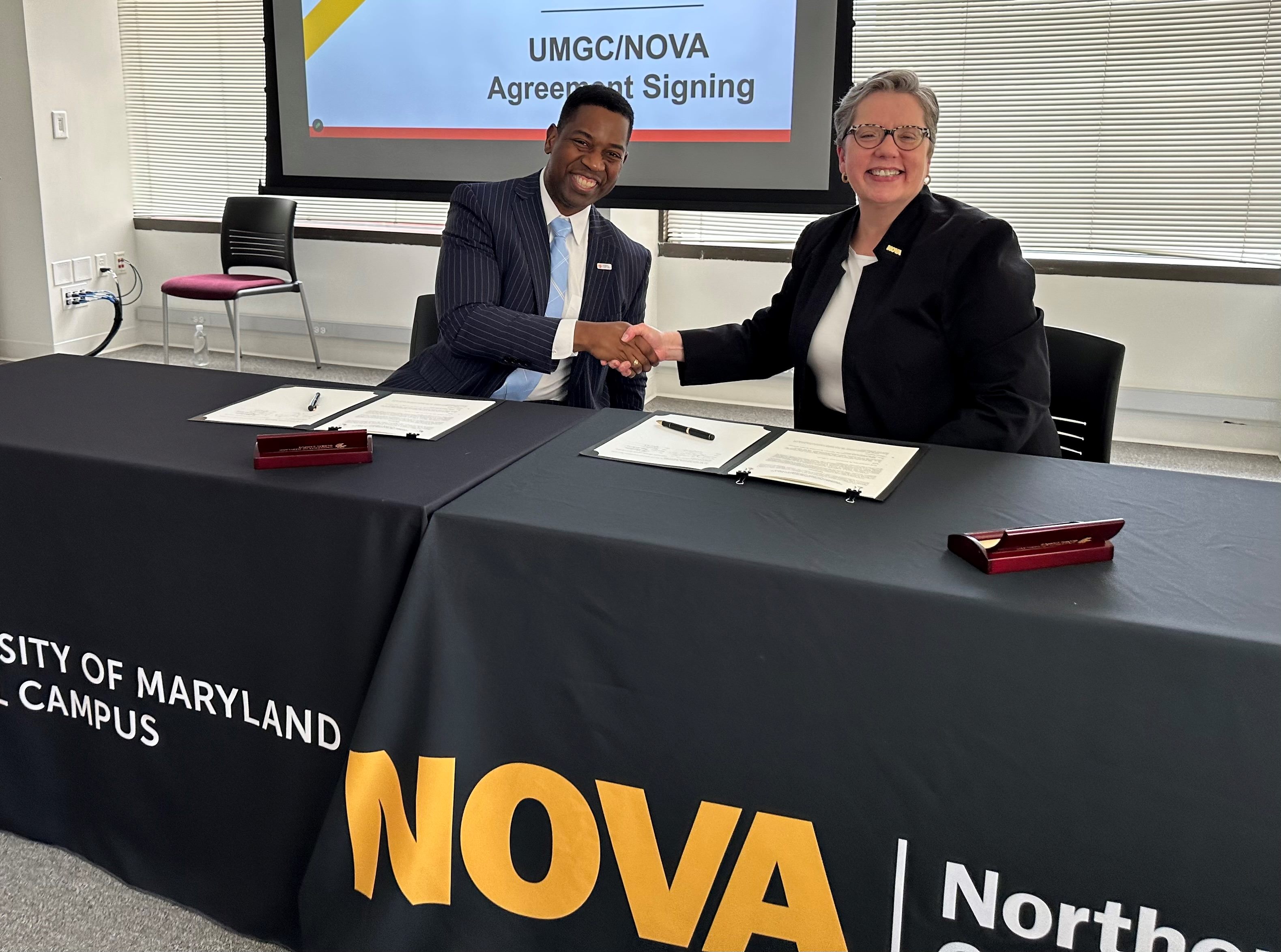 UMGC and NOVA presidents signing a memo of understanding.