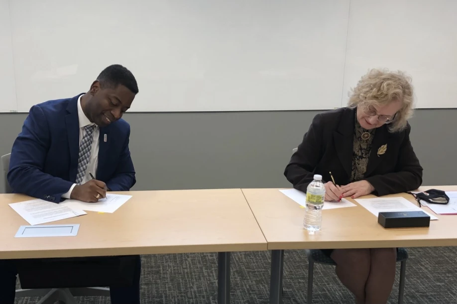 UMGC and Community College of Baltimore County presidents signing a memo of understanding.