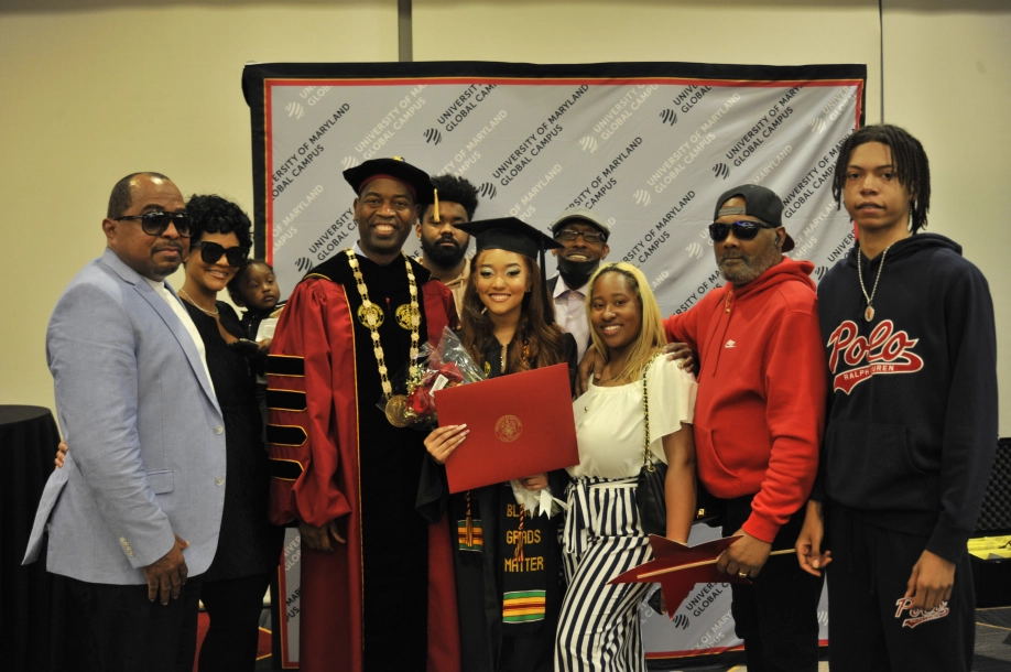 UMGC Graduates with family and Dr. Fowler.