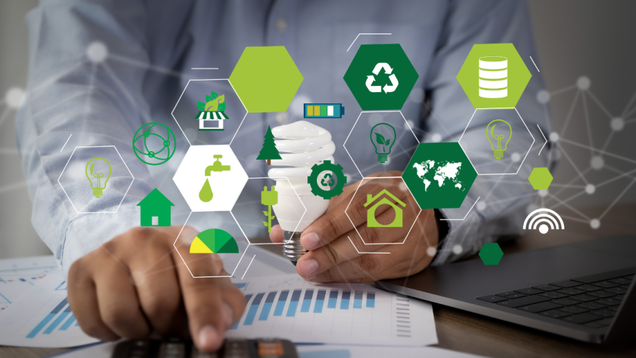 A man looking at graphs while eco-friendly iconography is around him.