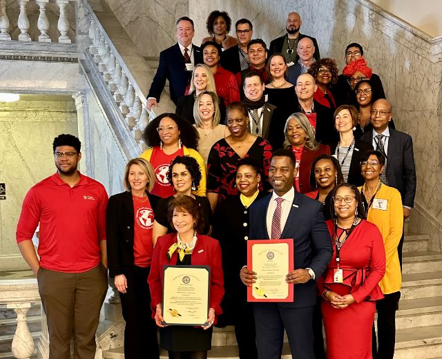 UMGC alumni, faculty, and staff join President Gregory Fowler in the Maryland State House with the resolution from the General Assembly