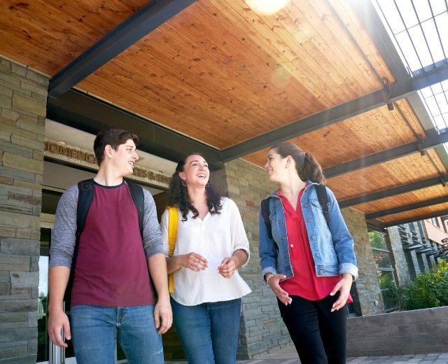 Three community college students on campus 