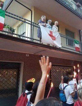 Italians drape red cross flags over bannisters during services.