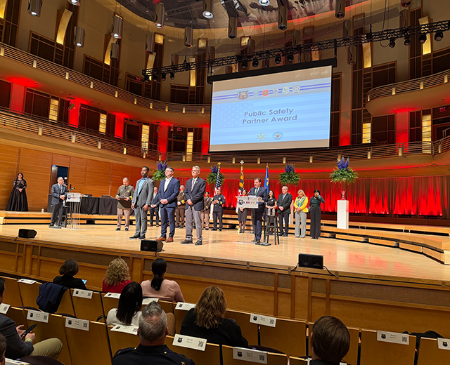 (From left) UMGC President Gregory Fowler, Director of Strategic Partnerships Justin Hasty, and Collegiate Professor Christopher Swain accept Montgomery County, Maryland's Public Safety Partner Award at the county's annual Public Safety Awards on Friday, March 13, in North Bethesda.