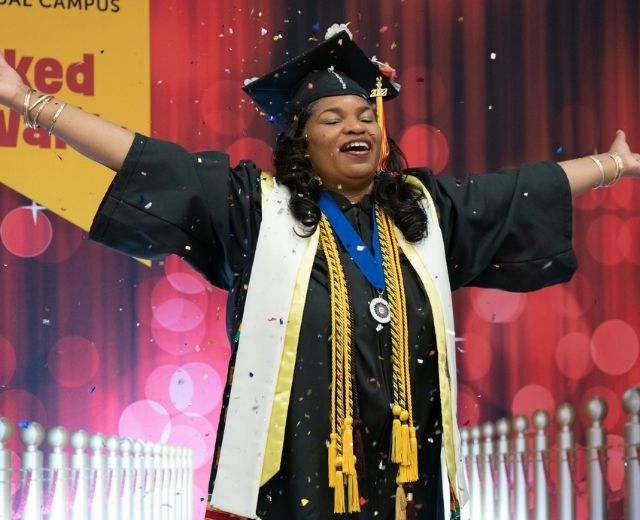 UMGC graduate at a Grad Walk celebration