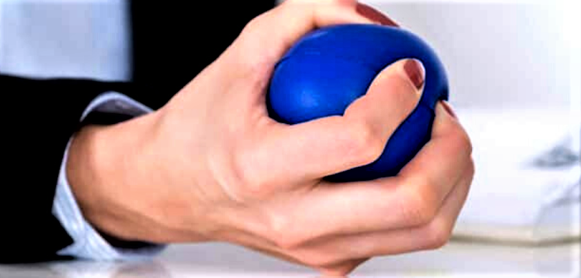 A person squeezing a stress ball.