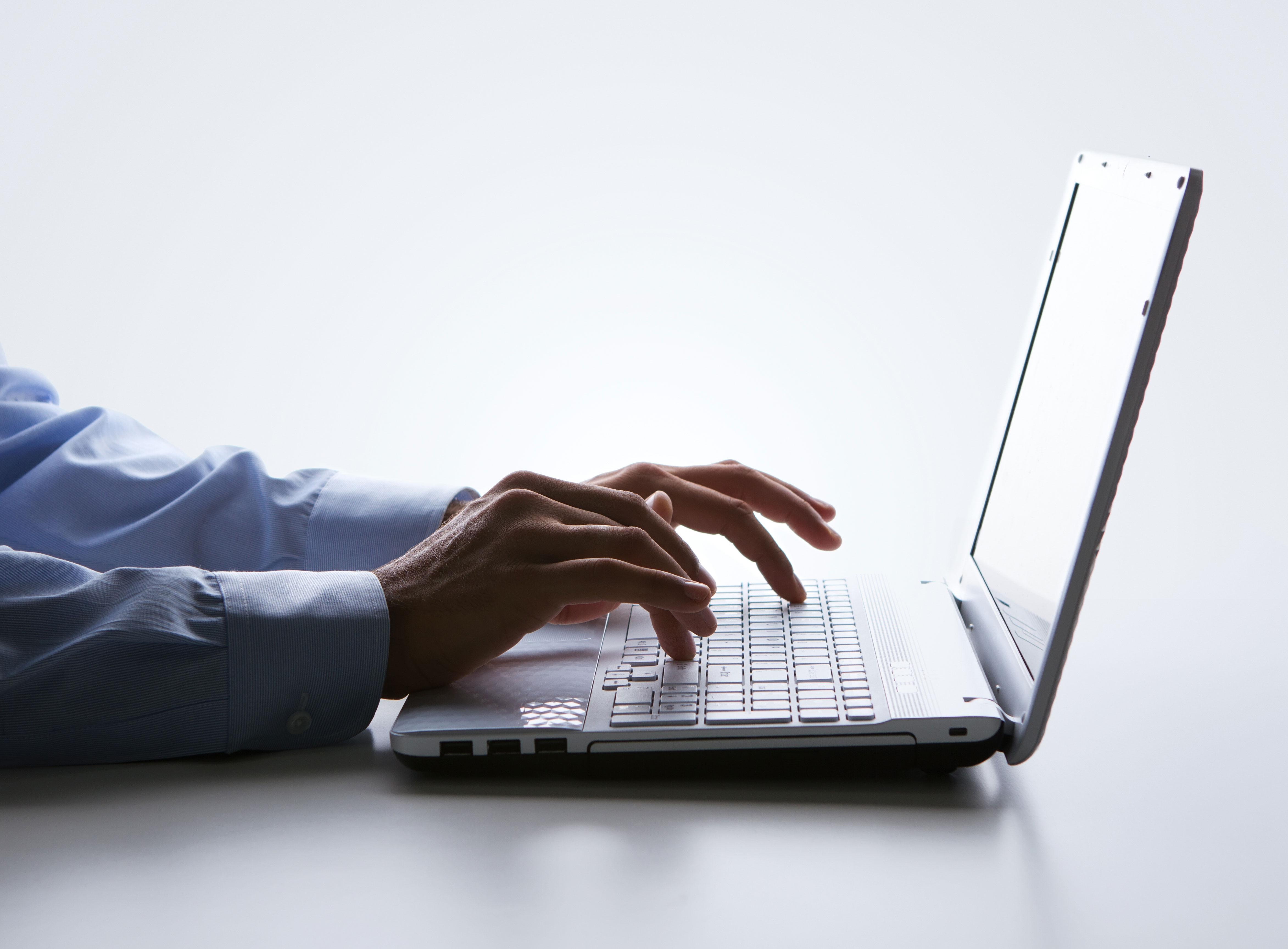 A man typing on his laptop.