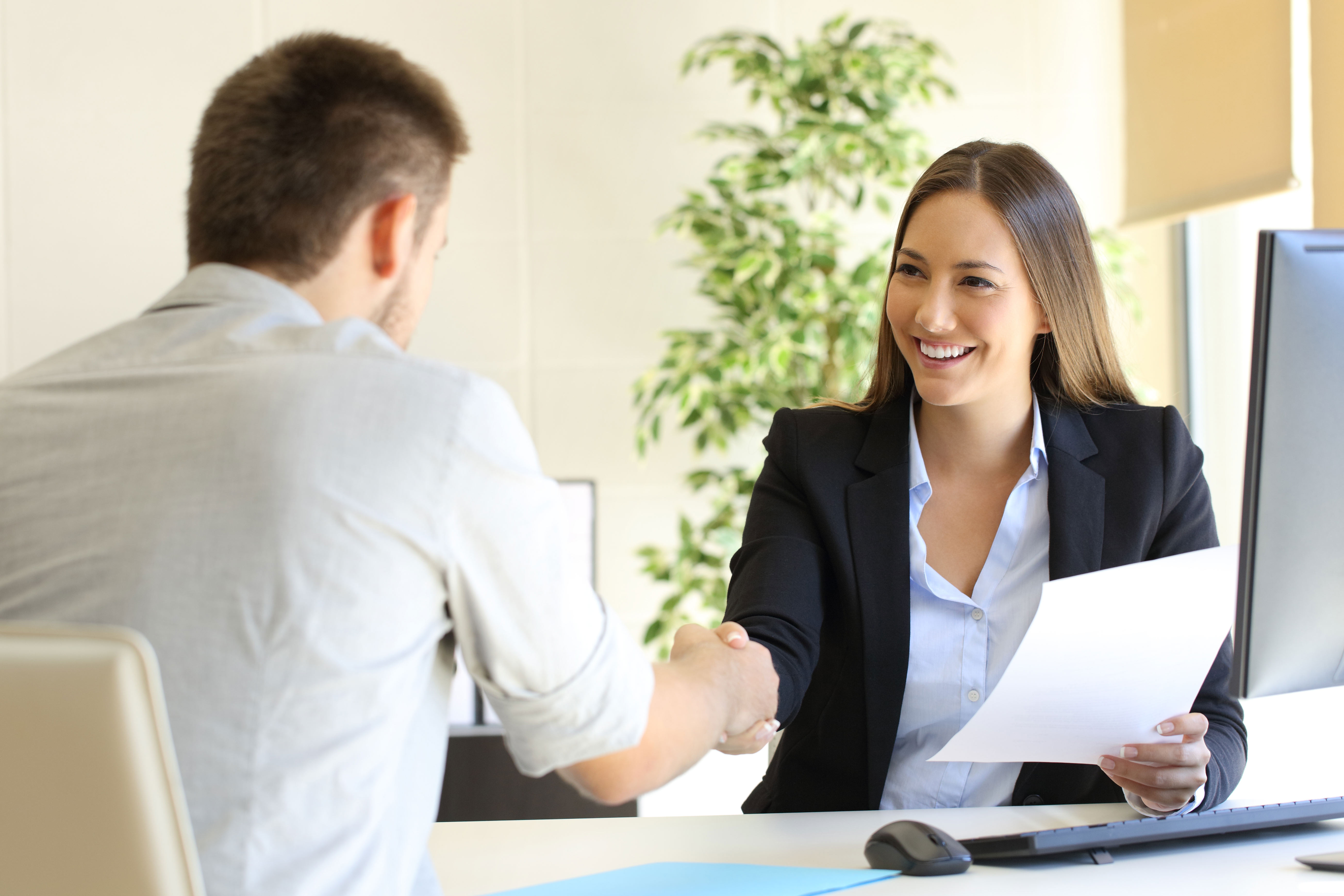 A man being interviewed by a woman.