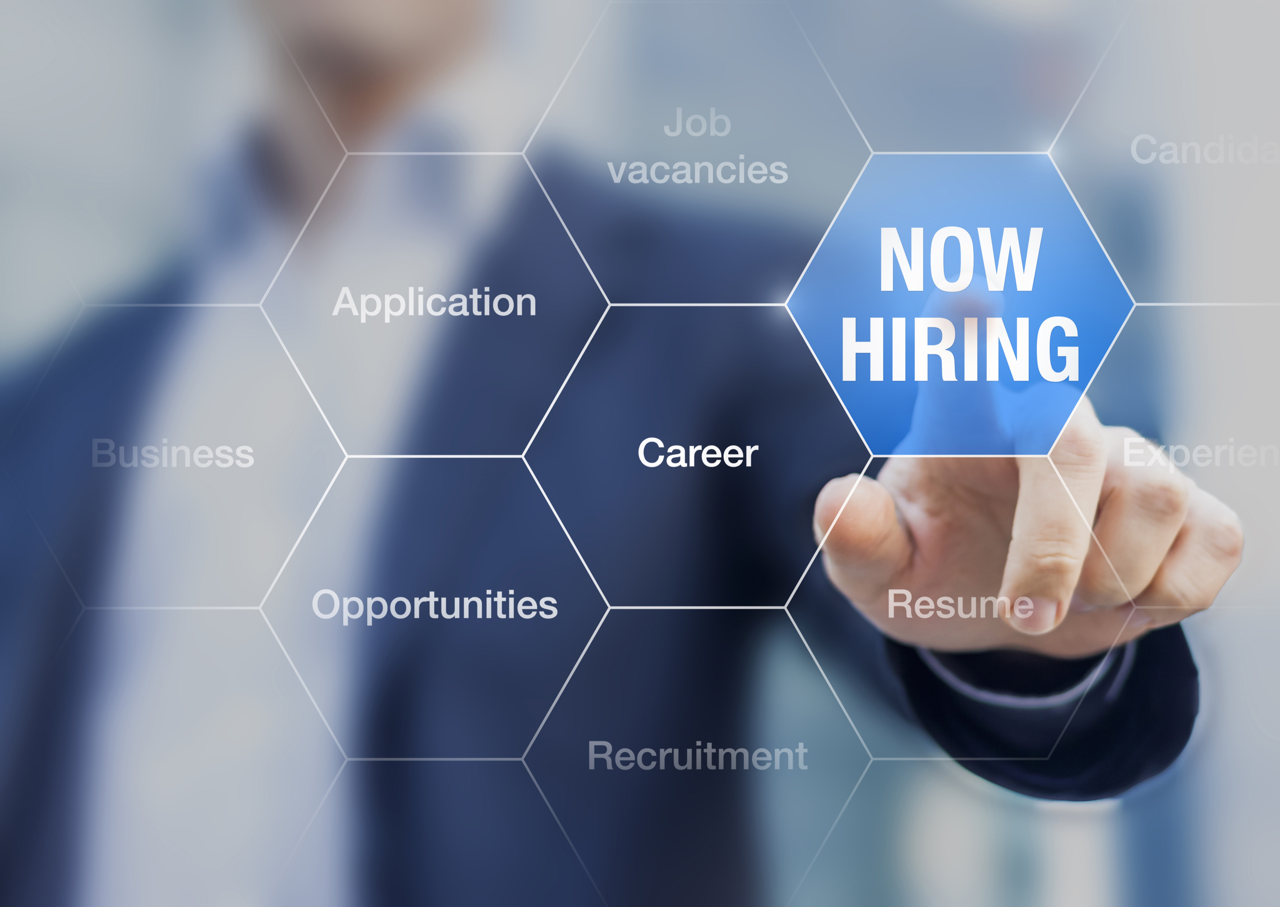 A professional touching an icon which says 'Now Hiring'