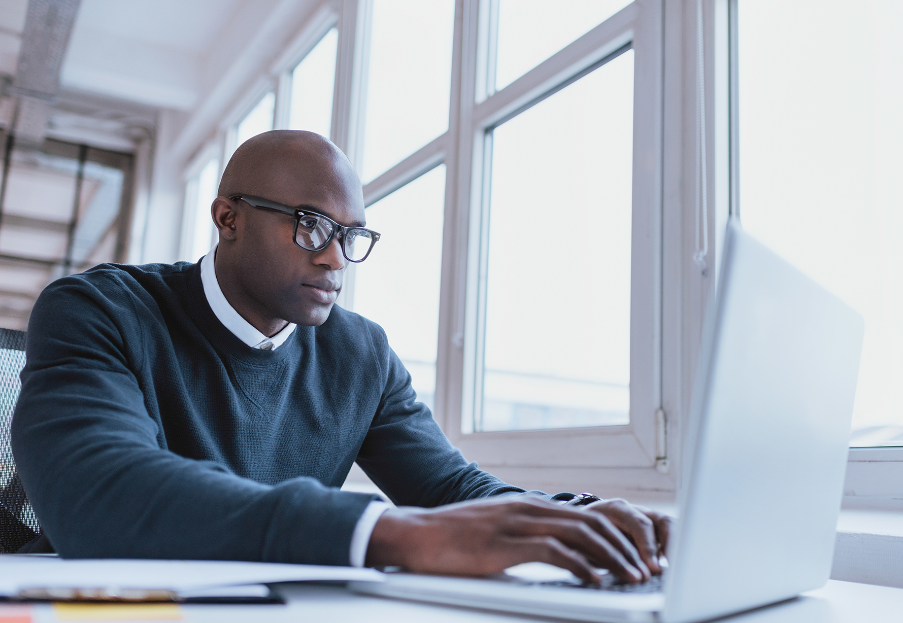A man working at a laptop.