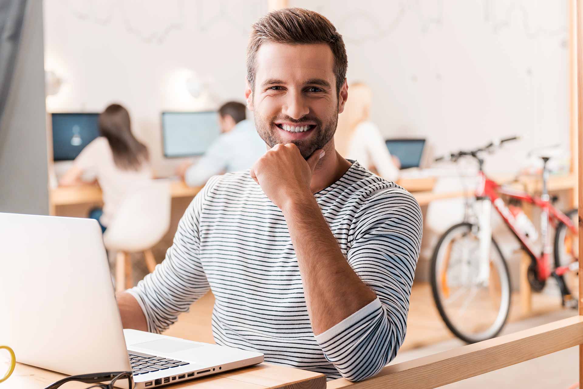 A man at his laptop working.