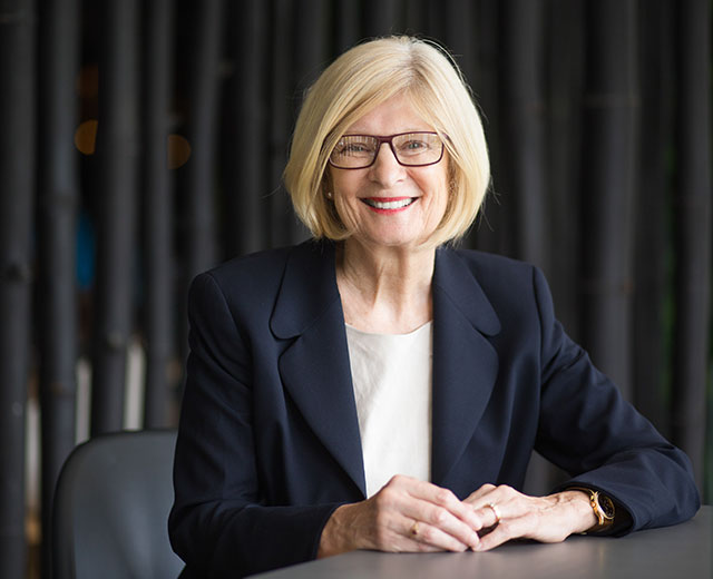 A professional woman sitting at a table.