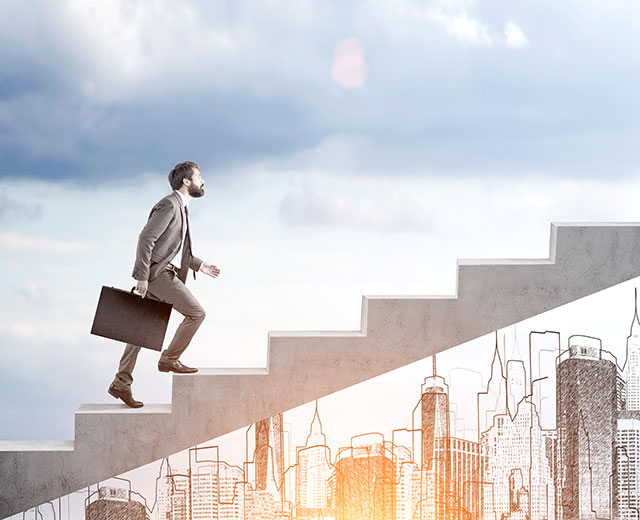 A man in a suit walking up a flight of stairs.