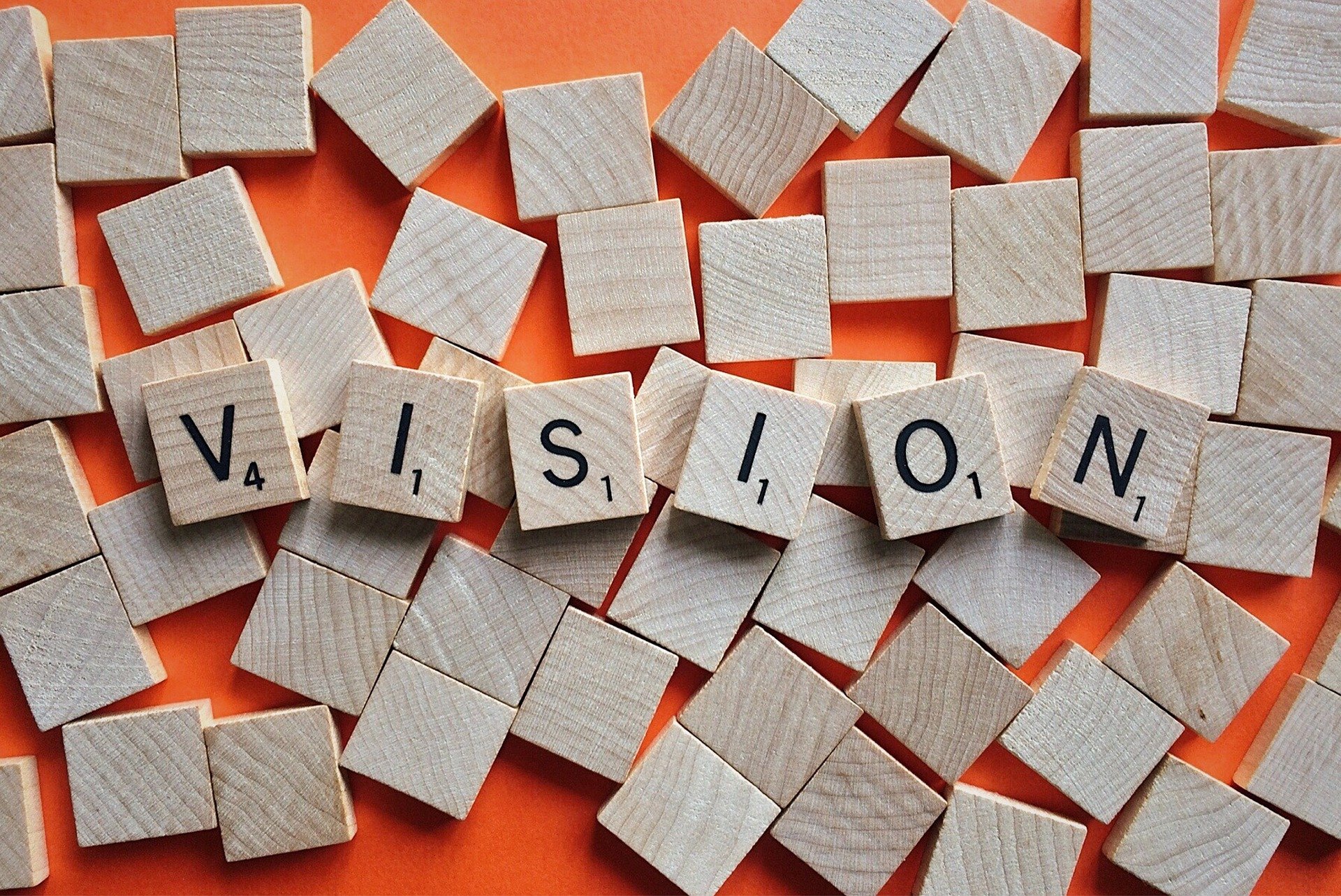 The word vision spelled out in scrabble tiles.