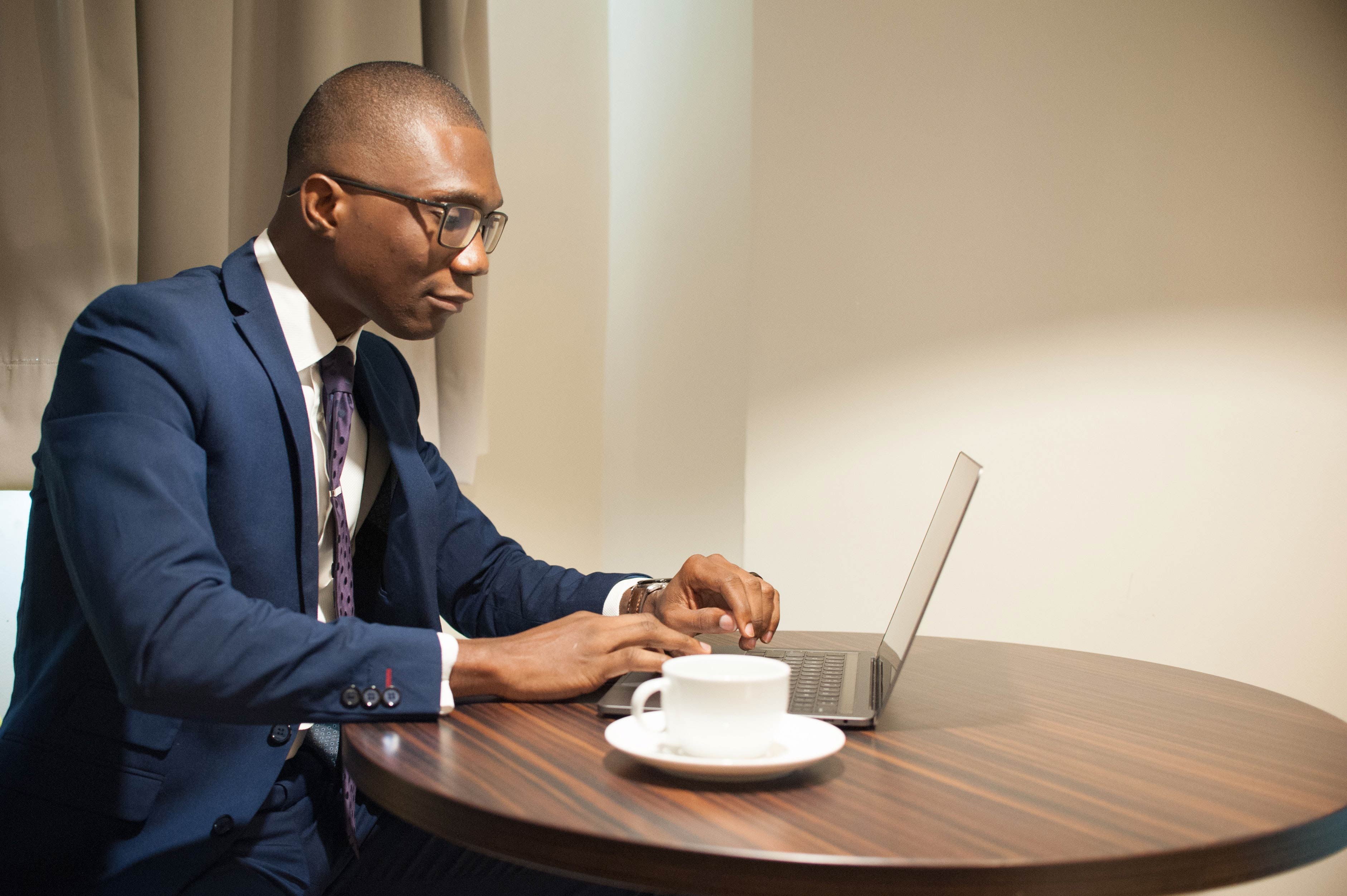 A man working at a laptop.