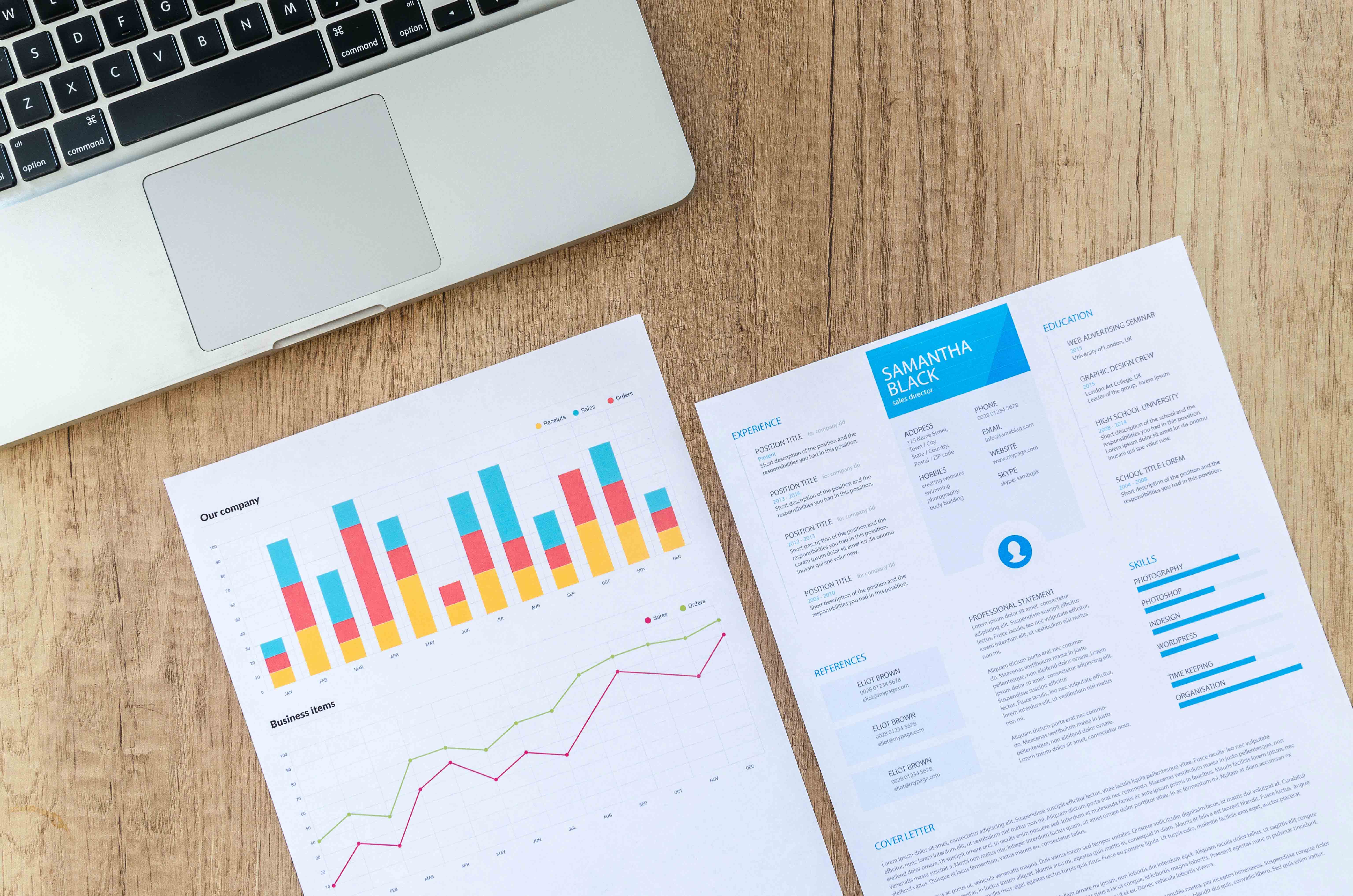 Two pieces of paper next to each other. The first shows a bar graph and line graph about 'our company' while the second shows a resume.