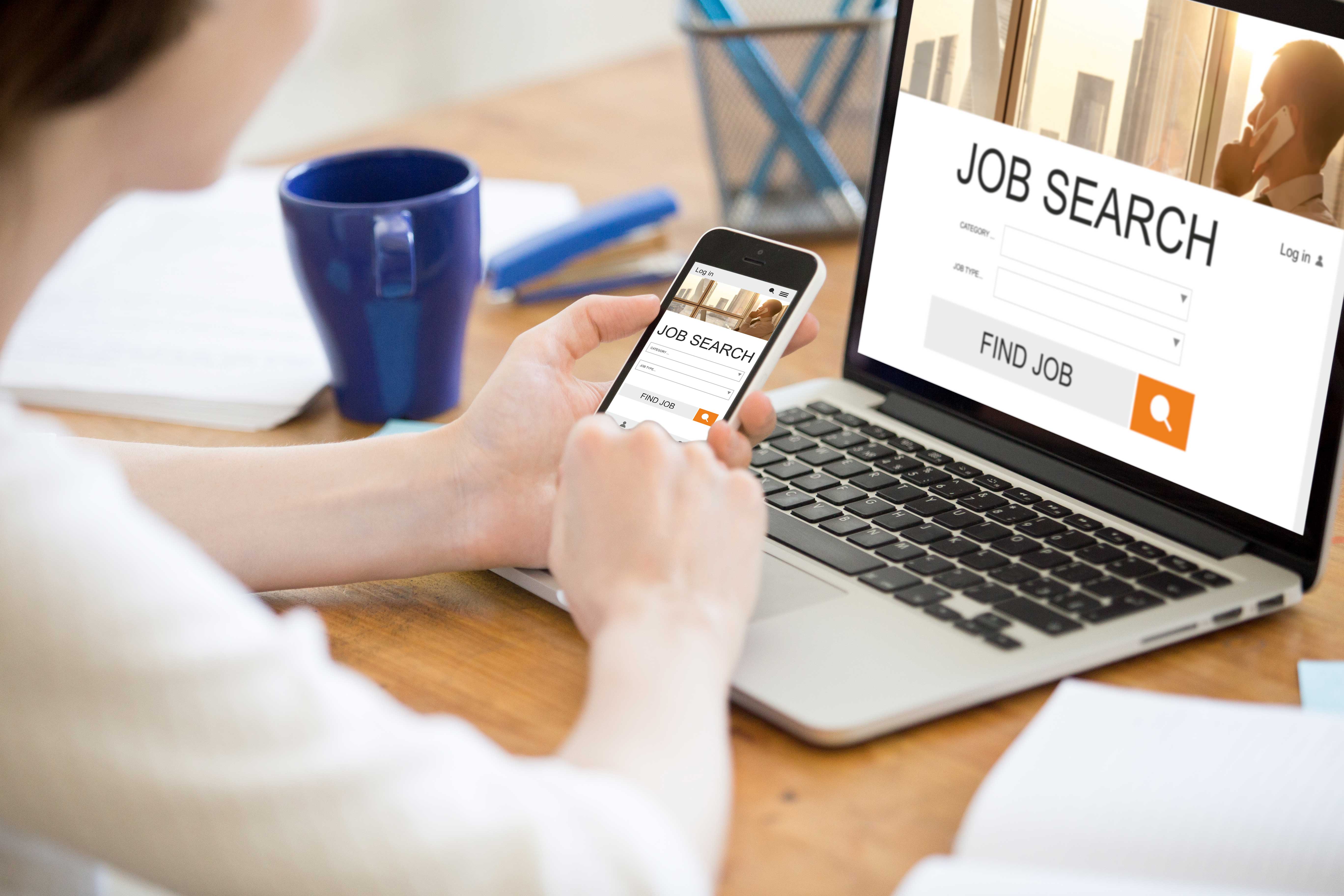 A person performing a job search on their laptop.