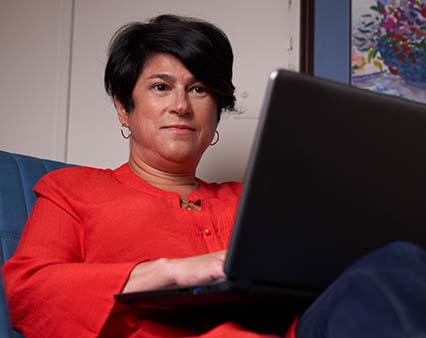 Woman sitting at computer looking at the screen