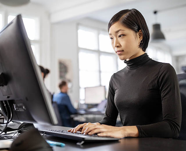 A person typing on a computer keyboard.