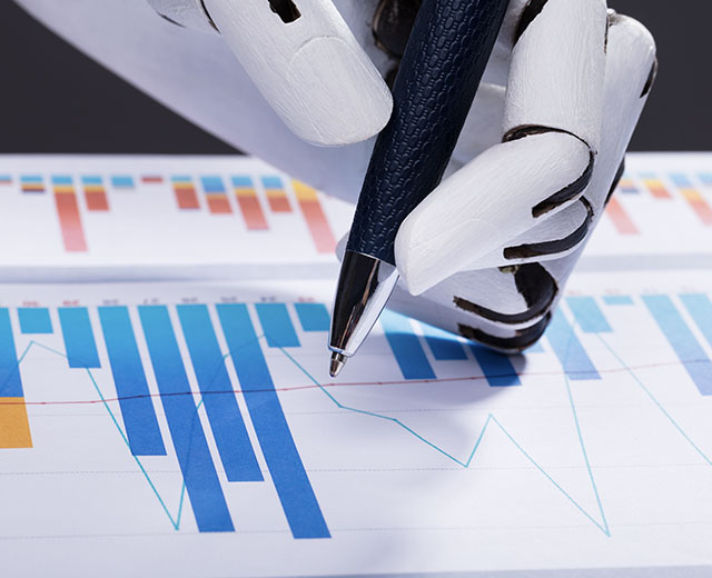 A robot's hand writing on a bar chart.